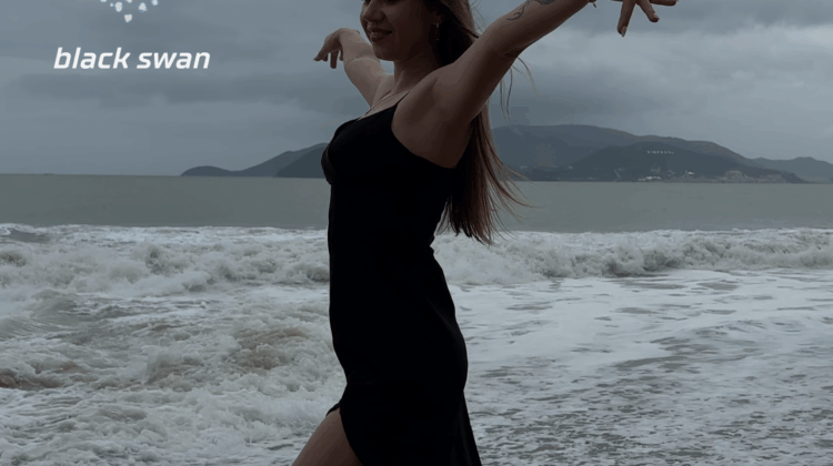 Black Swan Cover. Lisa on the Nha Trang beach in Vietnam, posing as a black swan in a black dress